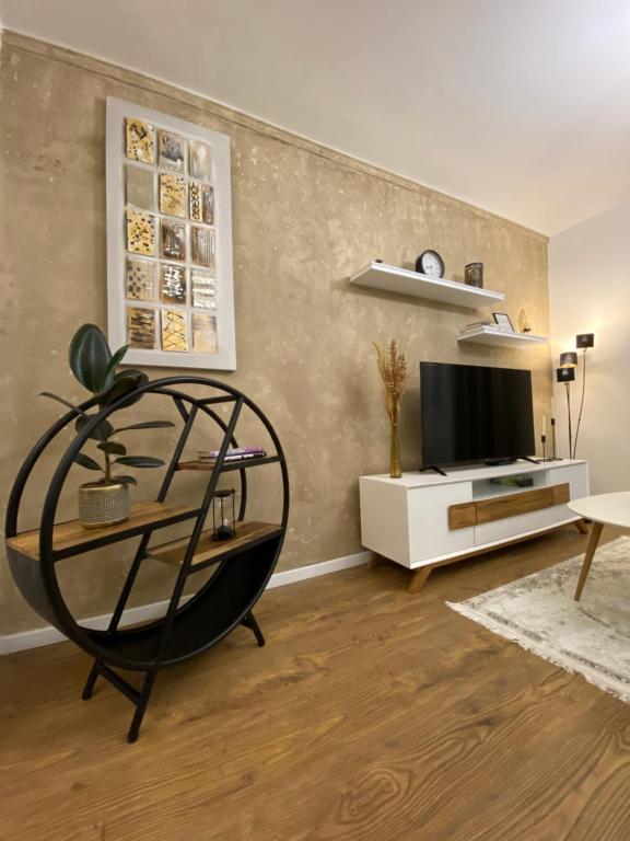 a living room with a tv and a table at Mountain View Apartment in Poprad