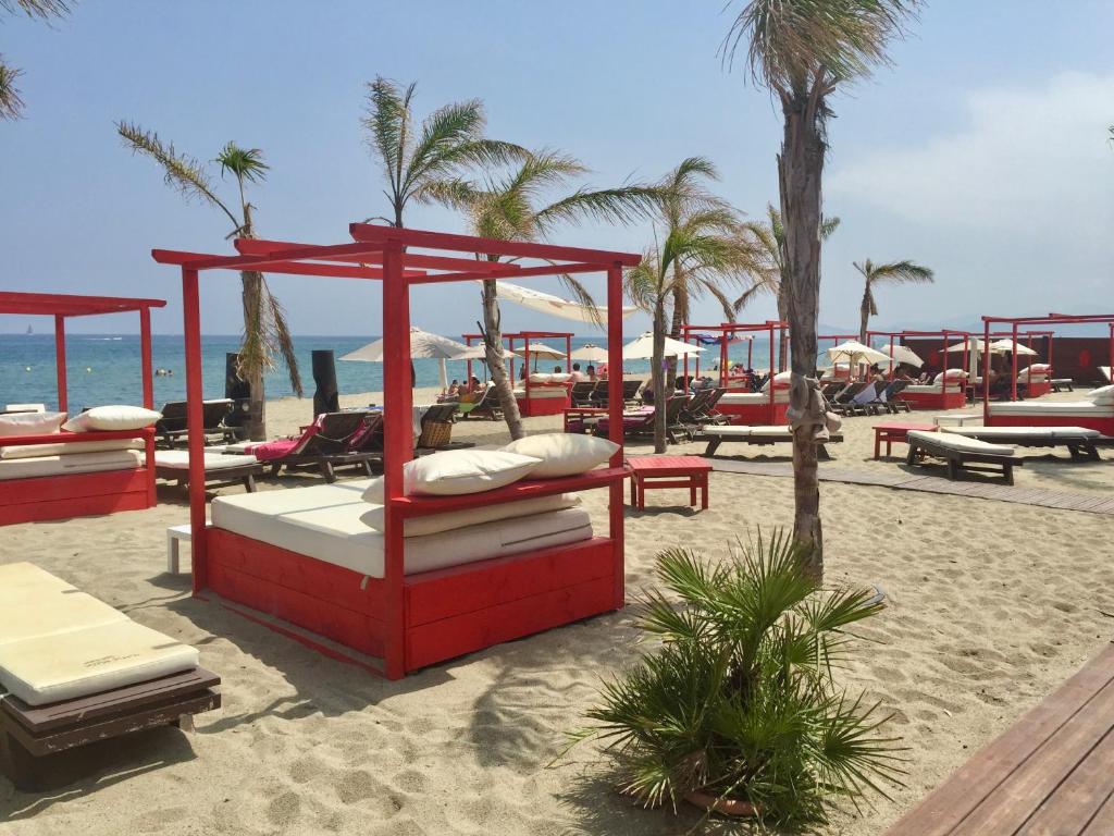 a red bed on the beach near the ocean at Maison Small Luxury ( planxa,suite,solarium,jacuzzi,pas de vis à vis) in Argelès-sur-Mer