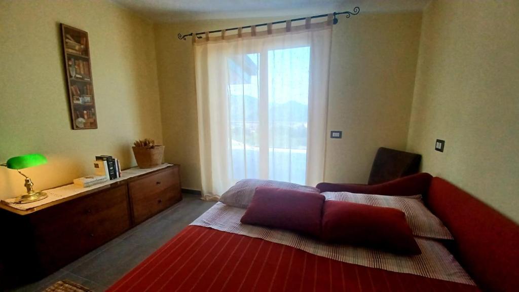 um quarto com uma cama e uma grande janela em Appartamento B&B La Meta em Fisciano