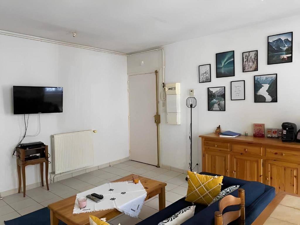 a living room with a couch and a table at Un moment de Détente au cœur de Vals-les-Bains in Vals-les-Bains