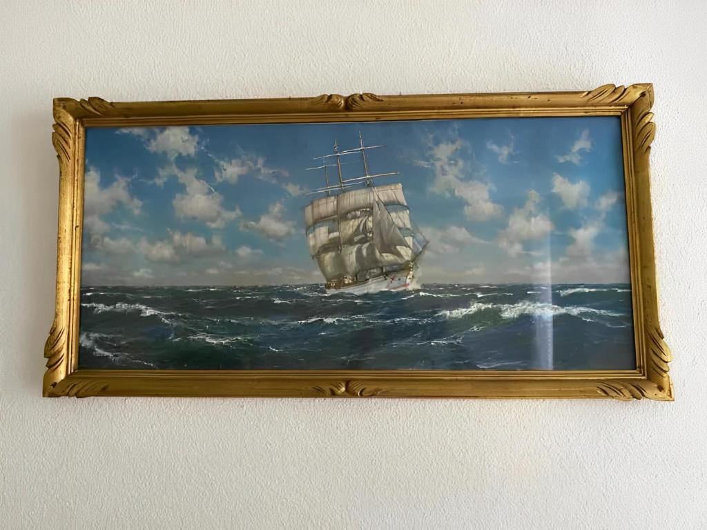 a picture of a painting of a ship in the ocean at Un moment de Détente au cœur de Vals-les-Bains in Vals-les-Bains