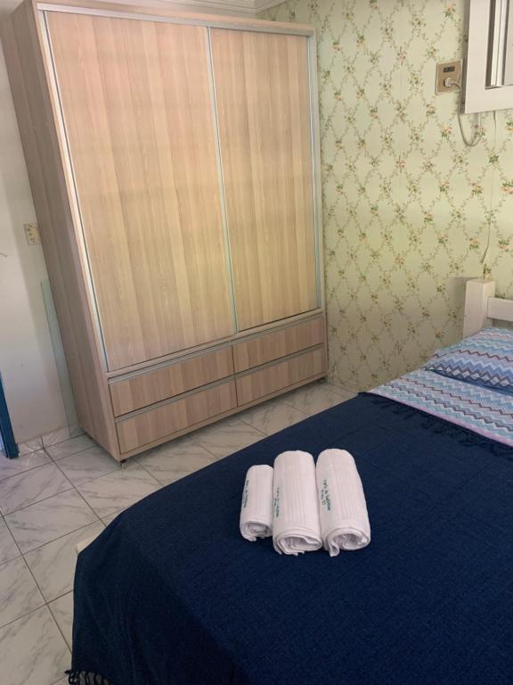 two white towels on a bed in a room at Porto Colore praça Sete in Porto De Galinhas