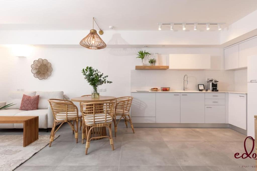 a kitchen and living room with a table and chairs at Family apartment next to the sea - By Edom in Eilat