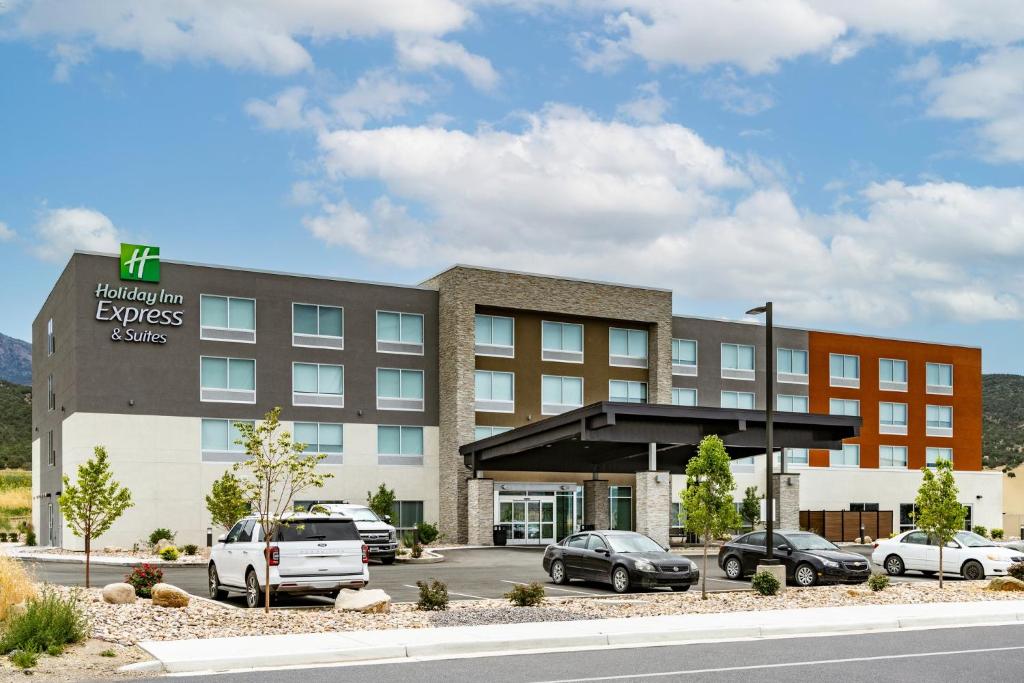 an office building with cars parked in a parking lot at Holiday Inn Express & Suites - Nephi, an IHG Hotel in Nephi