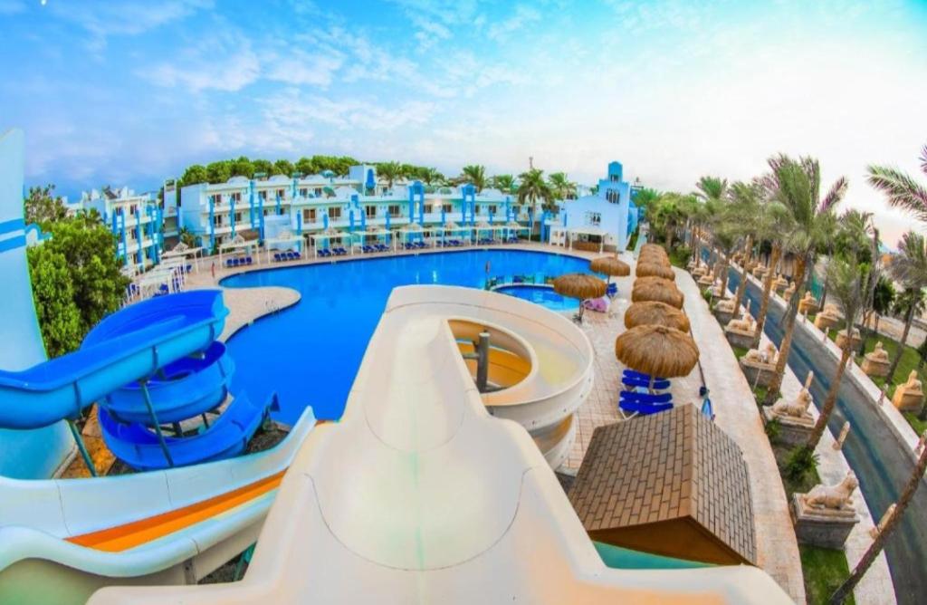 a pool at a resort with a water slide at Lillyland Mirage Bay & Aqua Park in Hurghada