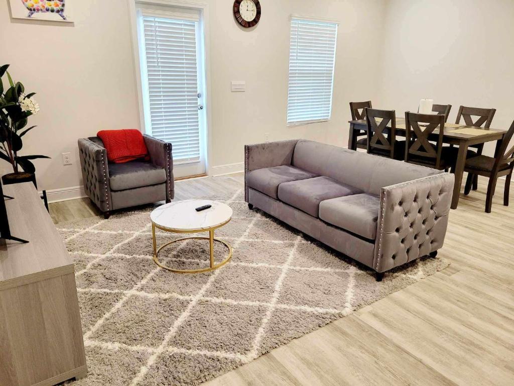 a living room with a couch and a table and chairs at Brand NEW house in Pensacola EV connector included in Pensacola