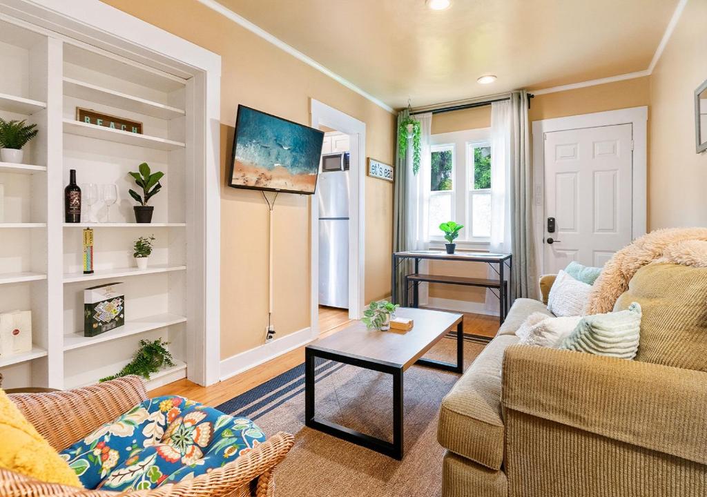 a living room with a couch and a table at Cozy Oceanside Retreat-Walk to Beach! in Oceanside