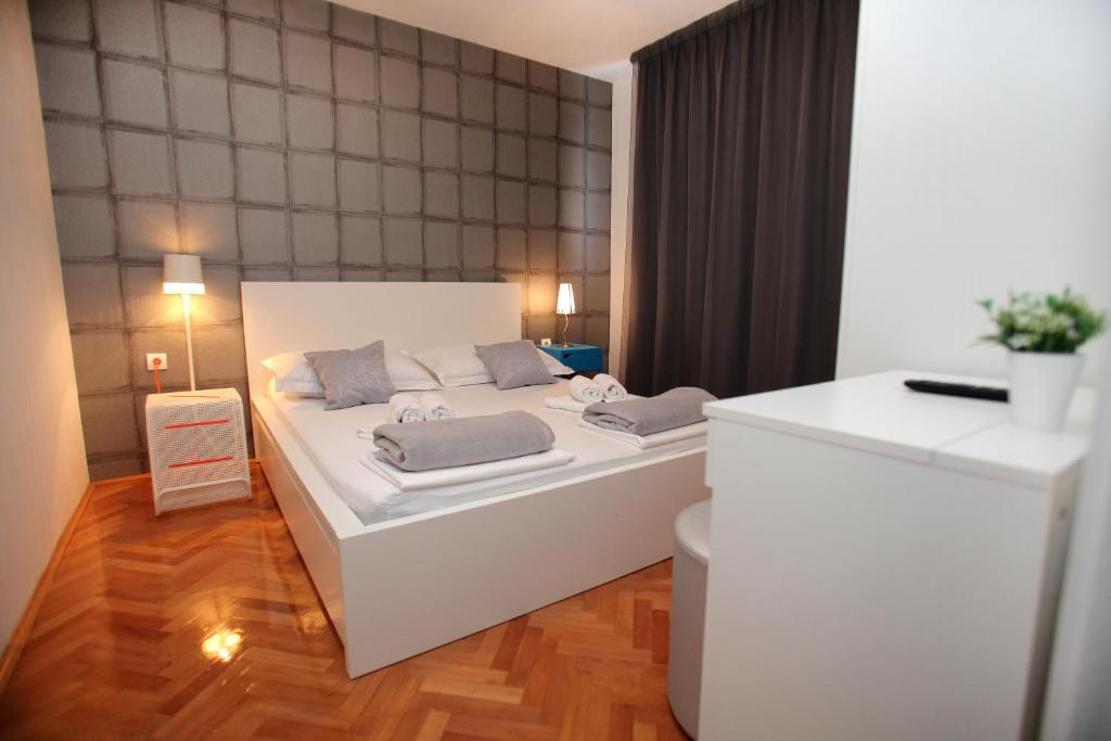 a bedroom with a white bed in a room at Happy Dreams Apartment near the beach and old town in Split