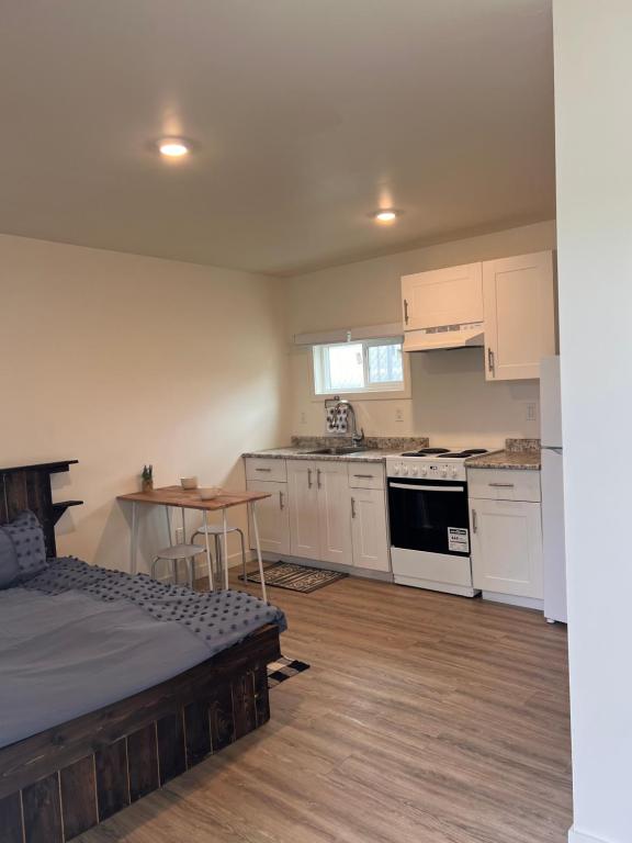 a kitchen with a bed and a table in a room at Studio apartment in Cranbrook