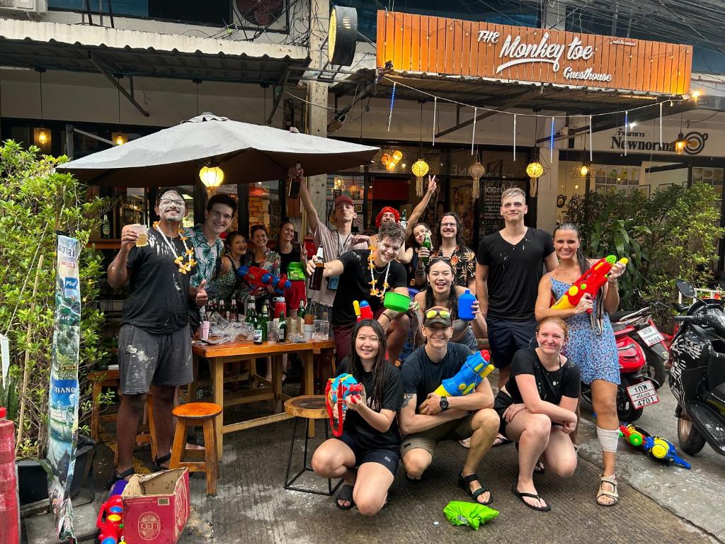 a group of people are posing for a picture at Monkey Toe Guesthouse in Chiang Mai