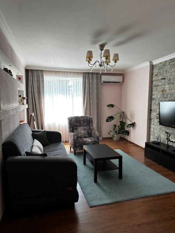 a living room with a couch and a table at Apartment on Agrba in Pizunda