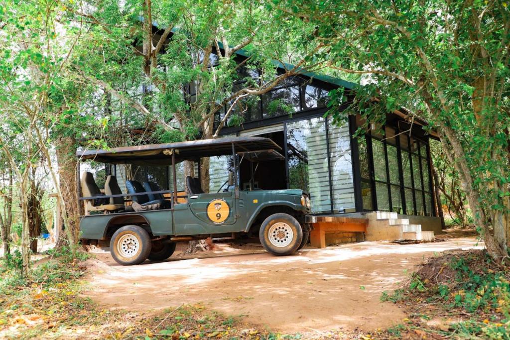 a green jeep parked in front of a house at Life of Leisure Wilpattu in Pahala Maragahawewa