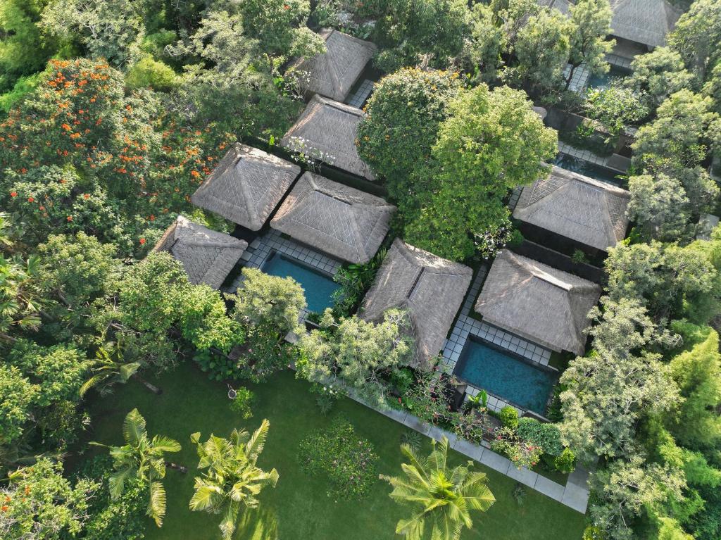 an aerial view of a resort with trees and water at The One Boutique Villa in Seminyak