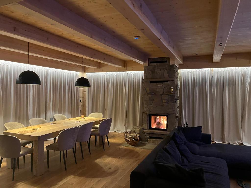 a dining room with a table and a fireplace at Dom Bio - Unique Ski Chalet, Białka Tatrzańska, Slovakia, Zakopane in Białka Tatrzańska