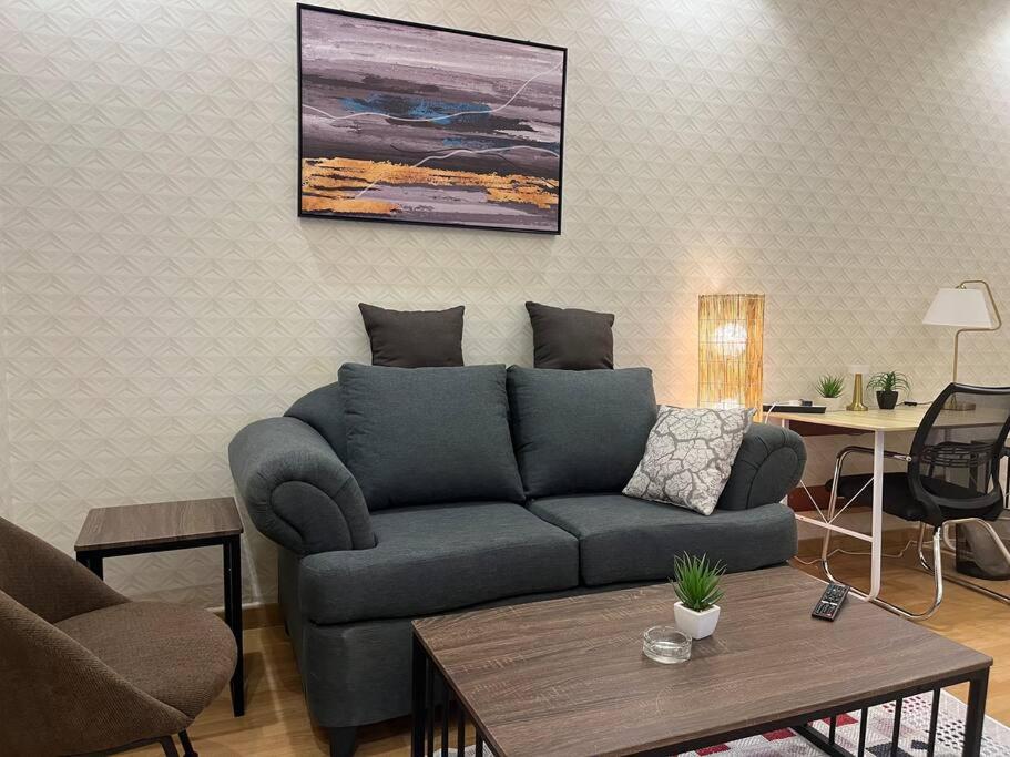a living room with a couch and a table at استديو فاخر ومريح in Riyadh