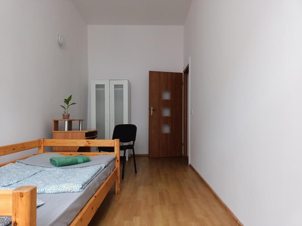 sypialnia z łóżkiem, biurkiem i krzesłem w obiekcie Cruz Mieszkanie Pokoje Centrum przytulny czysty lokal na noc w Łodzi