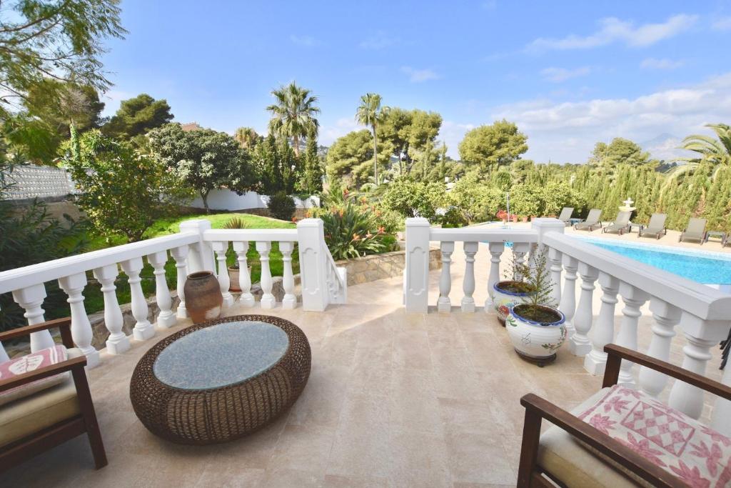 a patio with a white fence and a swimming pool at Apartments in a "VILLA VISTA JAVEA" in Jávea