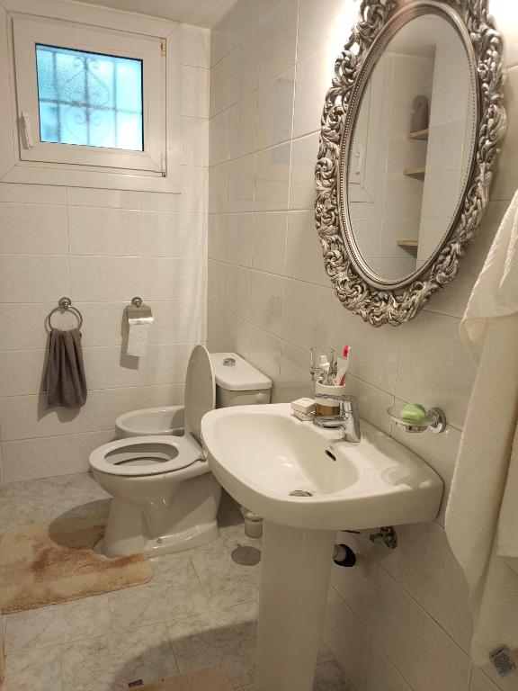 a bathroom with a toilet and a sink and a mirror at Apartments in a "VILLA VISTA JAVEA" in Jávea