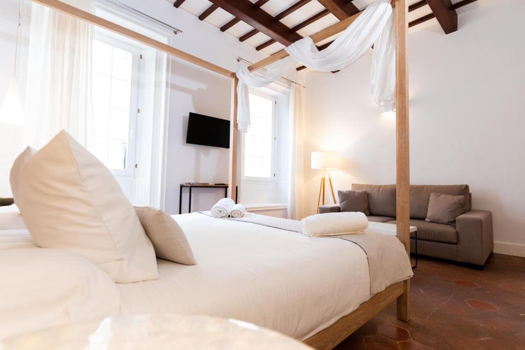 マオーにあるCan Roca Nouのベッドルーム(大きな白いベッド1台、ソファ付)