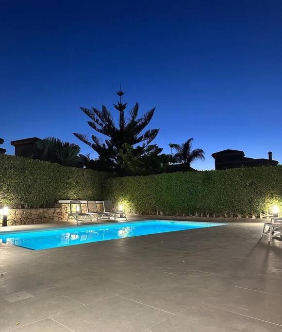 a swimming pool in a yard at night at Beautiful 3 bed villa on Mar Menor golf resort in Torre-Pacheco