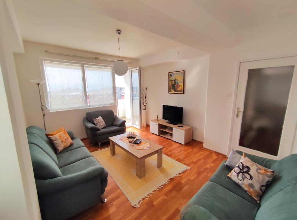a living room with two couches and a coffee table at Charming & Spacious 2 Bedroom Apartment with a Gorgeous 8th-floor view in Ohrid