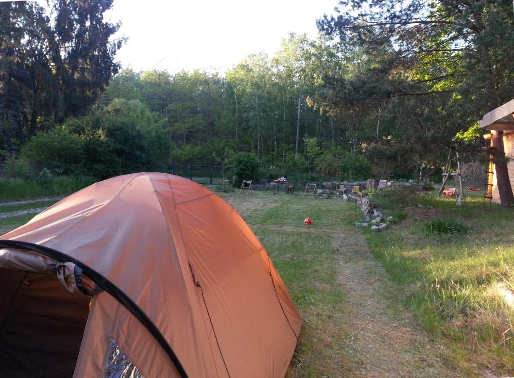 an orange tent sitting on the side of a field at Simplest-Camping in Biesenthal