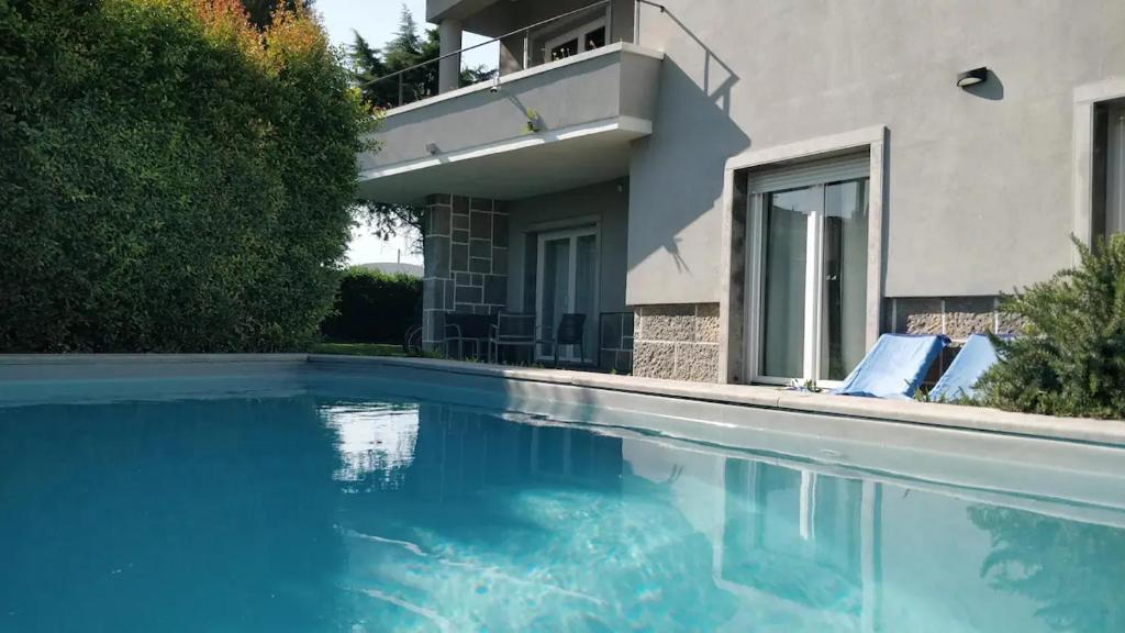 a swimming pool in front of a house at Casa Jasmim in Algueirão