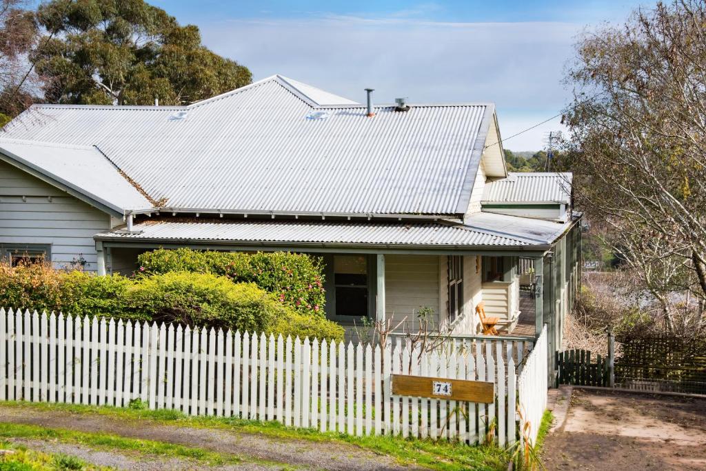 a white house with a fence in front of it at Brindabella in Daylesford