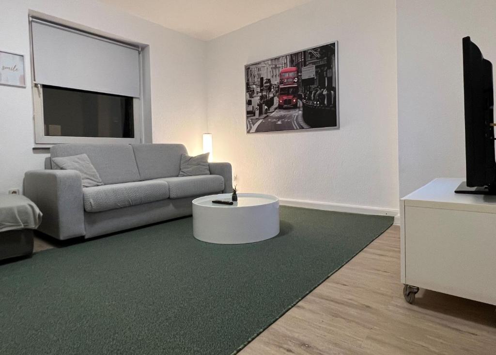 a living room with a couch and a tv at Wohnung mit Balkon am Rhein in Düsseldorf