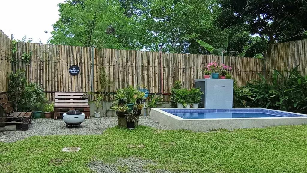 a backyard with a swimming pool and a wooden fence at The Backyard Glamp - Book The Entire Campground 