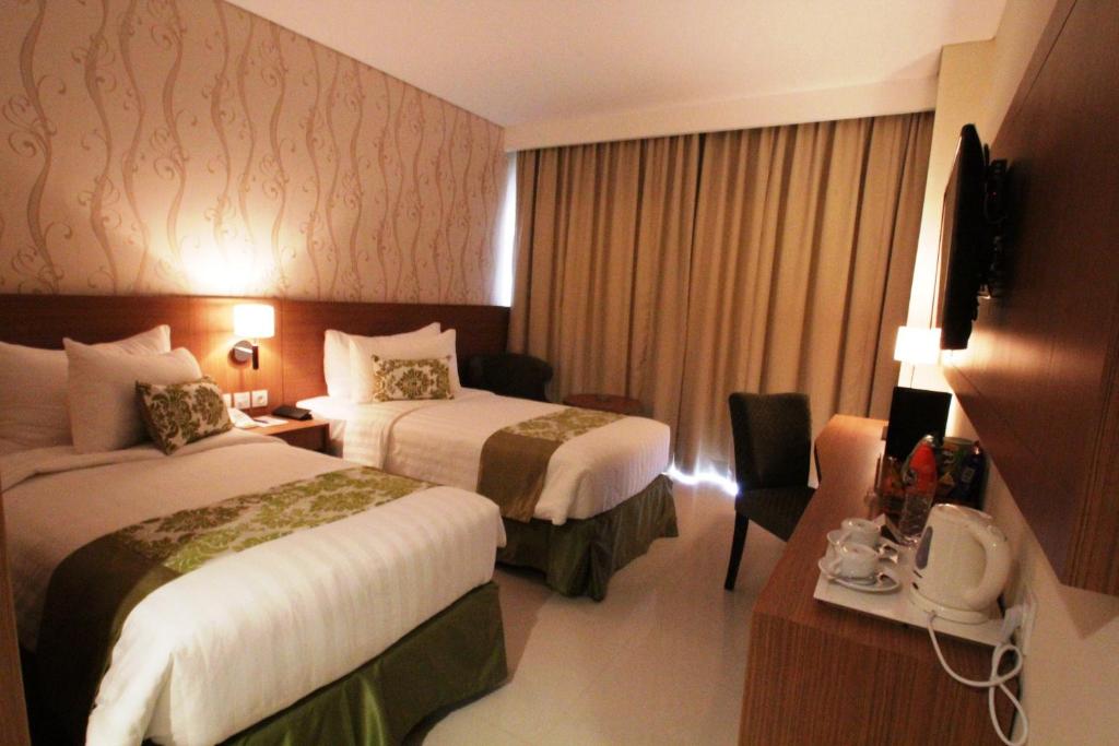 Postel nebo postele na pokoji v ubytování Ijen Suites Resort & Convention