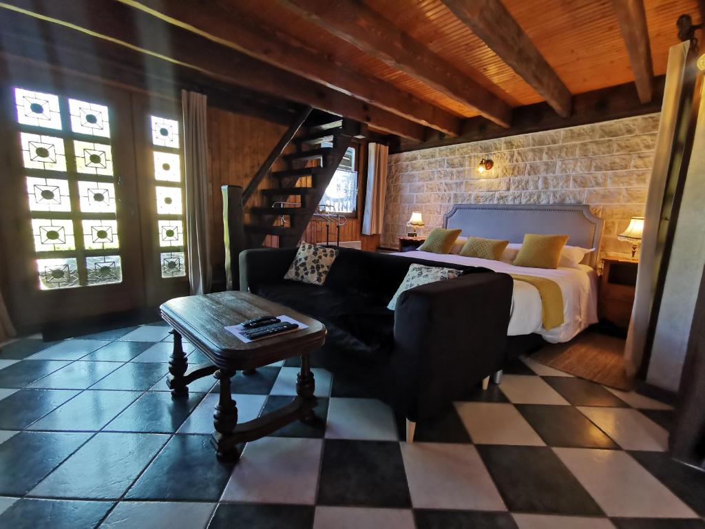 a bedroom with a bed and a couch and a table at Le gîte du Brouage in Chauny