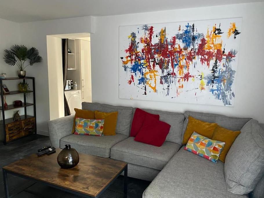 a living room with a couch and a painting on the wall at Modern 1 bed town centre apartment in Tamworth in Tamworth