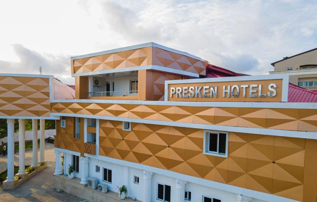 a hotel with a sign on the side of a building at Presken Waters in Lagos