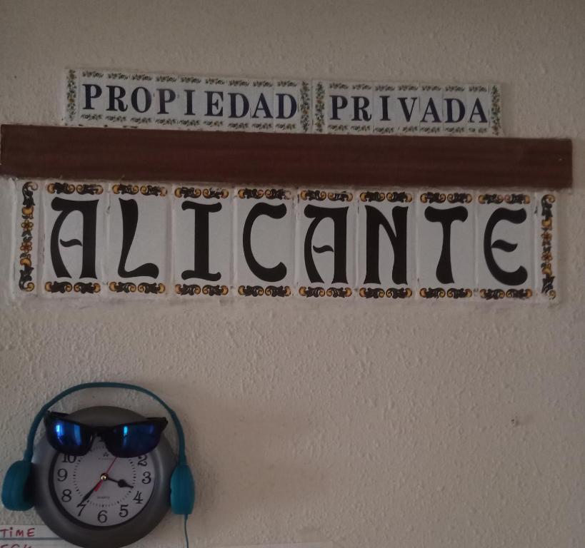 アリカンテにあるPensíon24Todoのアフリカを読む看板付き時計