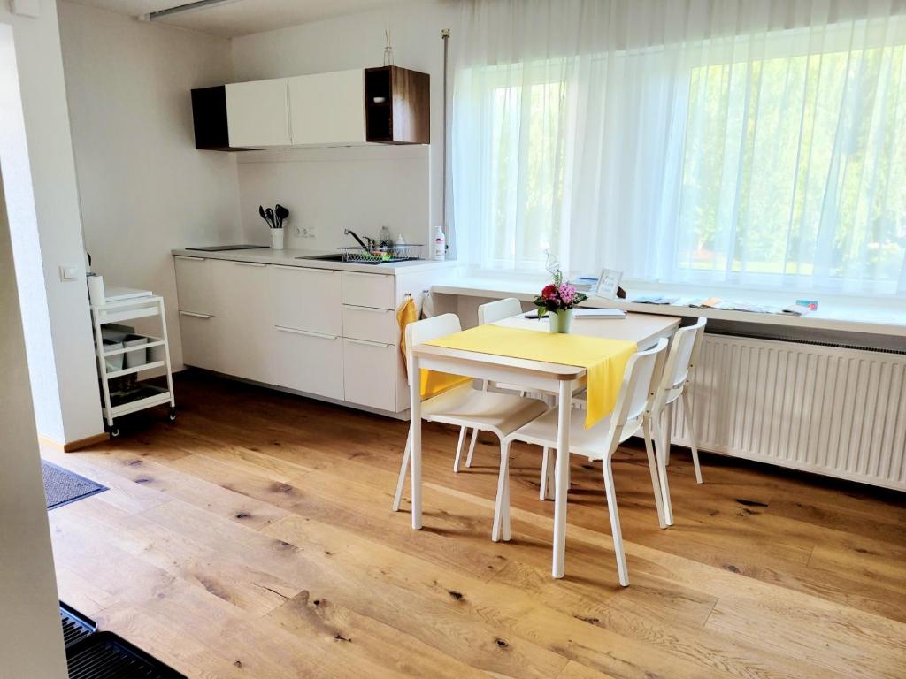 a kitchen with a yellow table and chairs in a room at Apartment Sonnenschein in Dornbirn