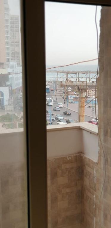 a window with a view of a parking lot at الاسكندريه in Alexandria