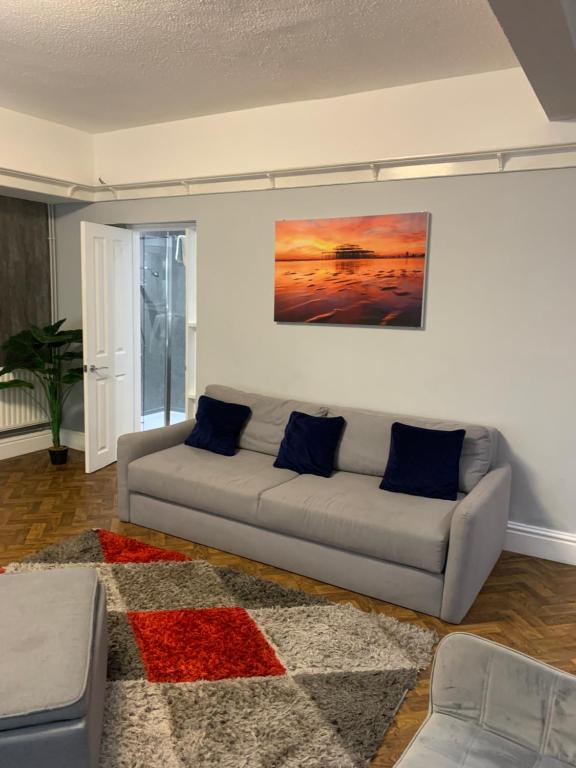 a living room with a couch and a painting on the wall at Entire apartment in central Brighton in Brighton & Hove