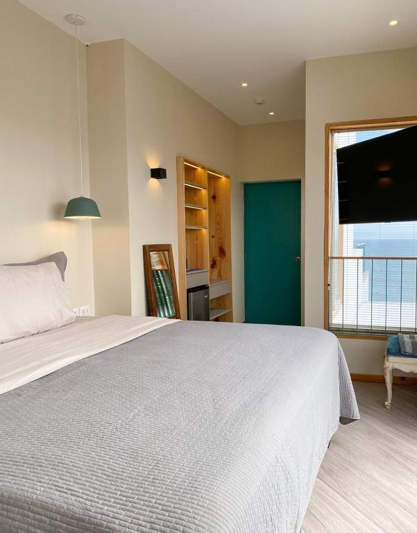 Postel nebo postele na pokoji v ubytování Kauhuhu Casa Hotel