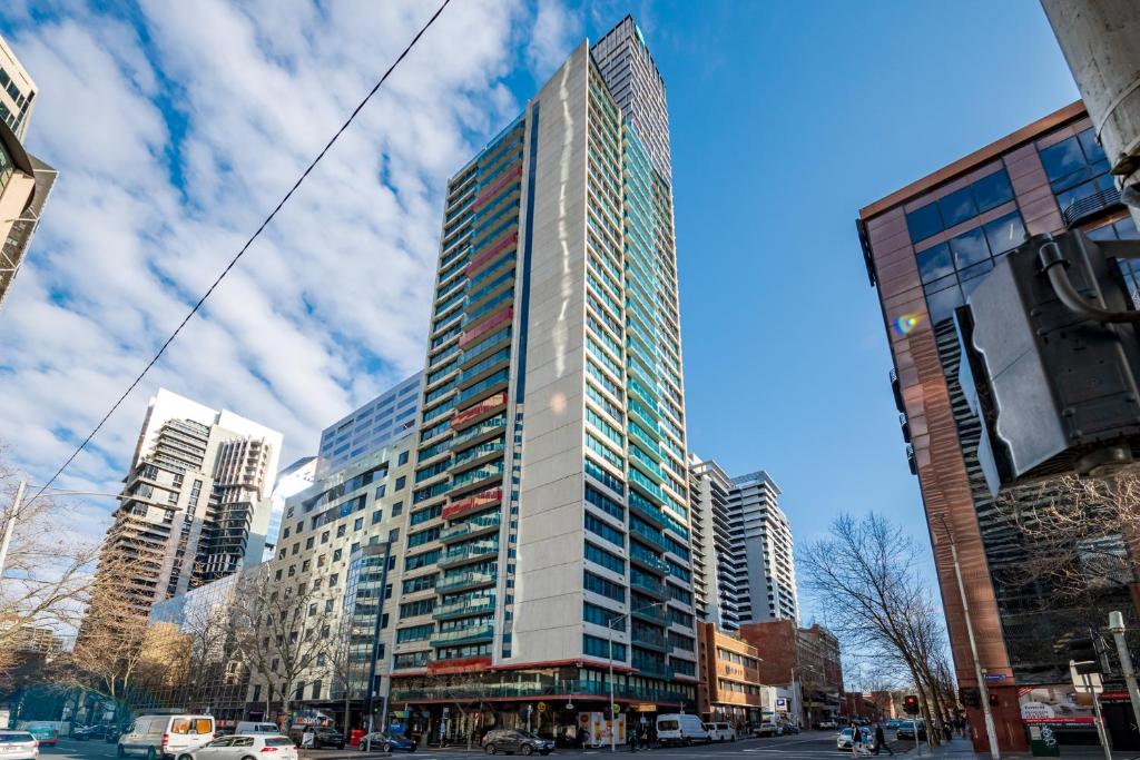 a tall building on a city street with buildings at City Stays in Melbourne