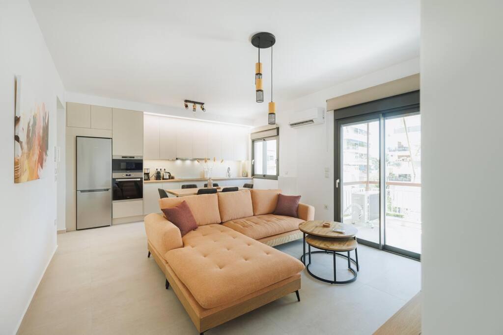 a living room with a couch and a table at Lavish condo in Athens Riviera in Athens