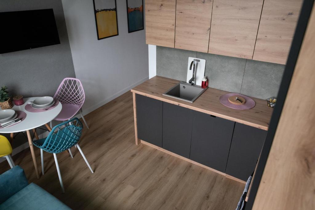 a small kitchen with a sink and a table at VS Apartments - apartament nr 33 in Łódź