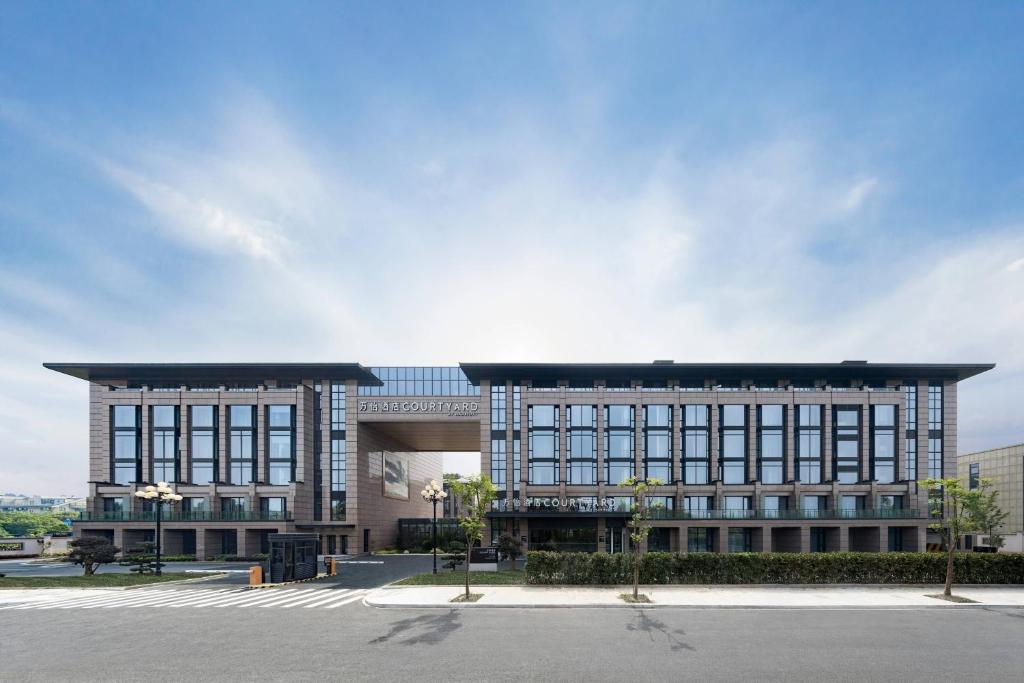a large building with a lot of windows at Courtyard by Marriott Hangzhou West in Hangzhou
