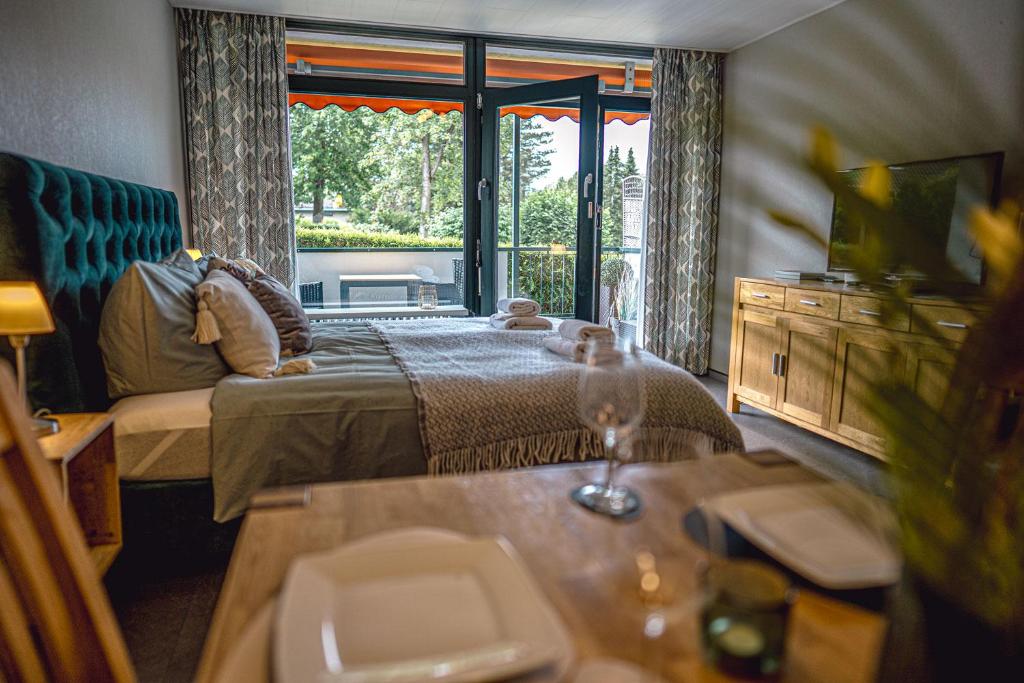 メーネゼーにあるSonnenstube mit Pool und Saunaのベッド1台、ソファ、窓が備わる客室です。