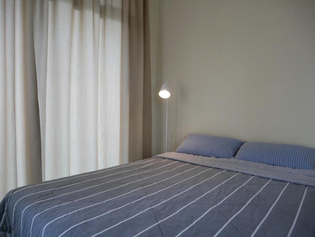 Postel nebo postele na pokoji v ubytování Jome Putrajaya Presint 8 Natural Homestay