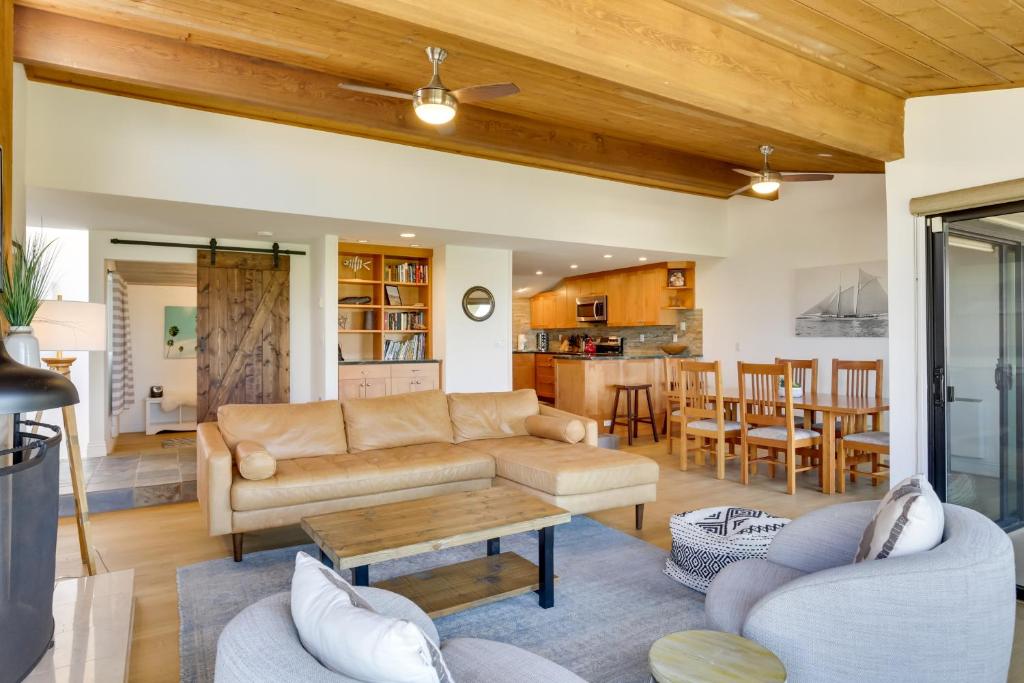 a living room with a couch and a table at Stunning Solana Beach Condo with Community Pools! in Solana Beach