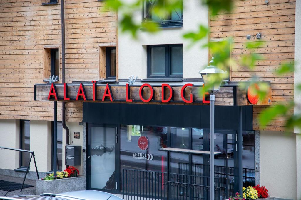 a restaurant sign on the front of a building at Alaïa Lodge in Crans-Montana