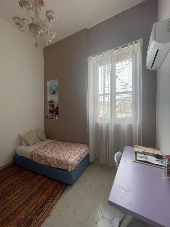 a small bedroom with a bed and a window at Viromar in Naples
