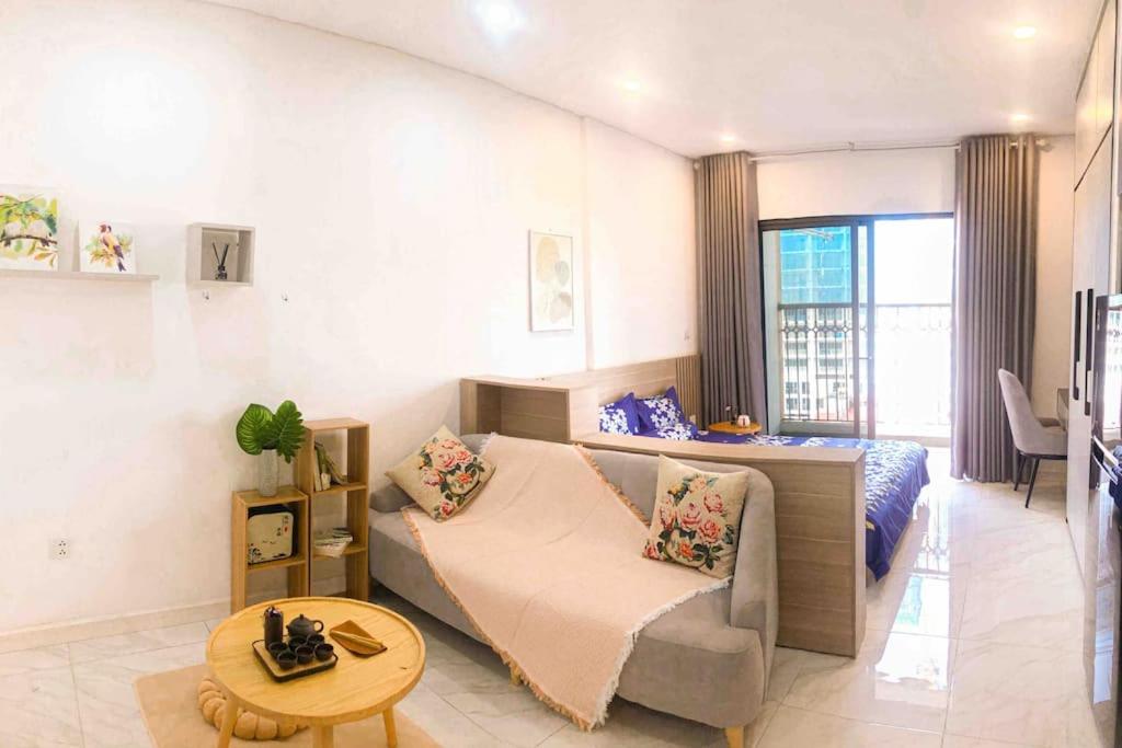 a living room with a couch and a bed and a table at Lakeview apartment - 5 minutes to Westlake - 20' to Noi bai airport in Hanoi