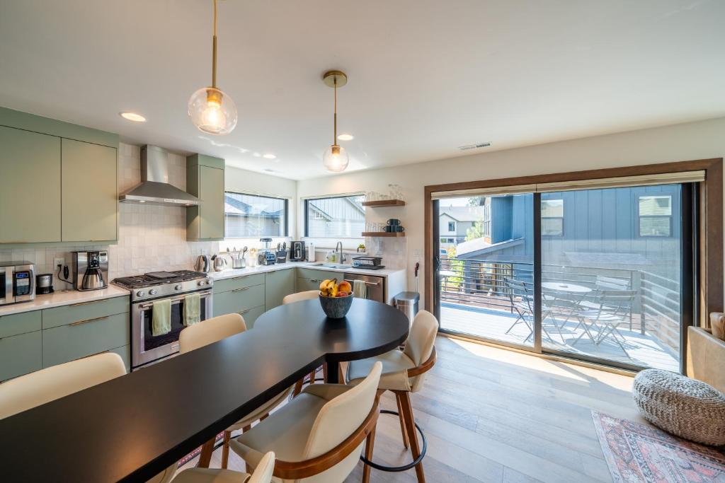 a kitchen with a table and chairs and a large window at Mini Marshmallow 30 Days minimum apts in Bend
